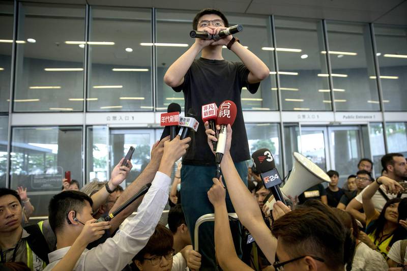 epaselect epa07653371 Demosisto Secretary General and pro-democracy activist Joshua Wong talks to the media after being released from prison, outside the Legislative Council building, in Hong Kong, China, 17 June 2019. His release comes as Hong Kong is rocked by huge protests to oppose a plan allowing extraditions to China. Wong said the protests would continue until Hong Kong Chief Executive Carrie Lam resigned.  EPA/JEROME FAVRE