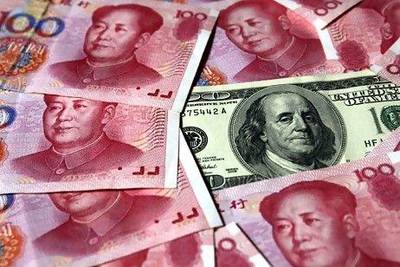 The bulk of China's $3.2 trillion official foreign reserves - more than 60 per cent - is denominated in dollars, including $1.1tn in US Treasury bonds. Petar Kujundzic / Reuters