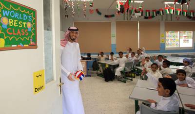 ABU DHABI - UNITED ARAB EMIRATES - 09SEPT2012 - Ahmed al Maamari, Emirati teacher on his first day interacts with grade 3 students at Al Aasimah School, boys  government school at Shamkha Area in Abu Dhabi. Ravindranath K / The National