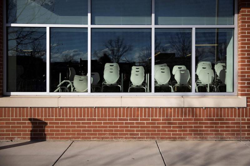Chairs are stacked near the windows of a classroom ahead of in-person learning at the Jefferson-Houston School in Alexandria, Virginia. Reuters
