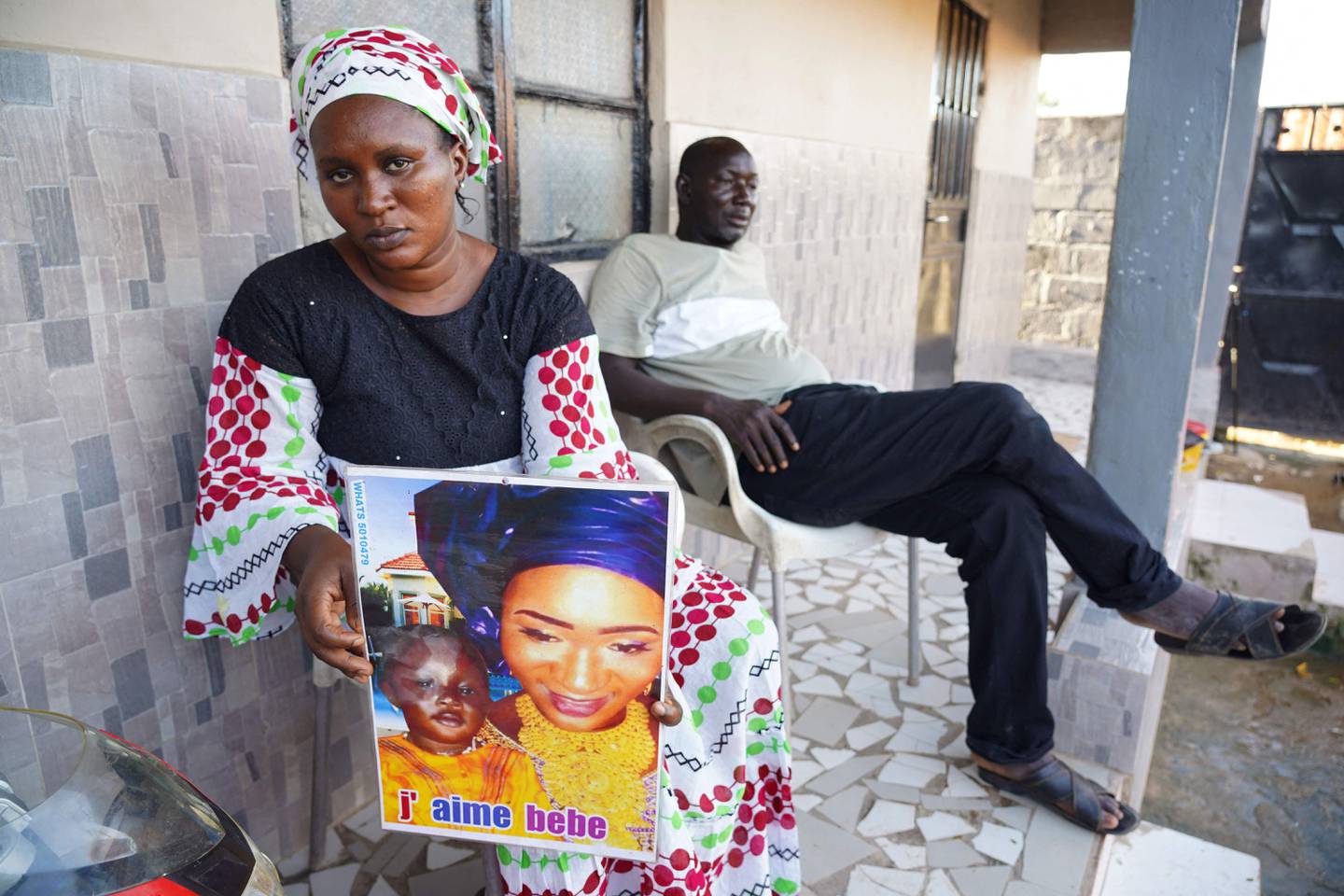 Mariama Kuyateh, holds up a picture of her late son, Musawho, died from acute kidney failure, in Banjul, Gambia. AFP