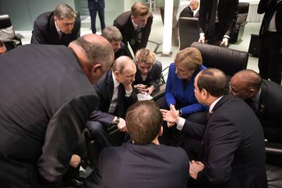 Egyptian President Abdul Fattah al-Sisi (R), Russian President Vladimir Putin (2ndL), German Chancellor Angela Merkel (2ndR) and French President Emmanuel Macron (front) talk on the sidelides of a Peace summit on Libya in Berlin.    AFP