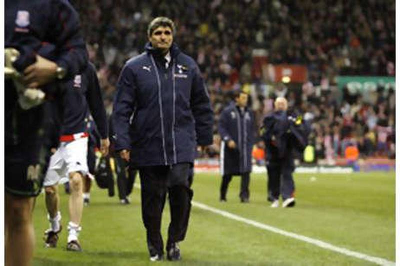 The Spurs manager Juande Ramos, centre, looks dejected after watching his side lose yet another game at Stoke.