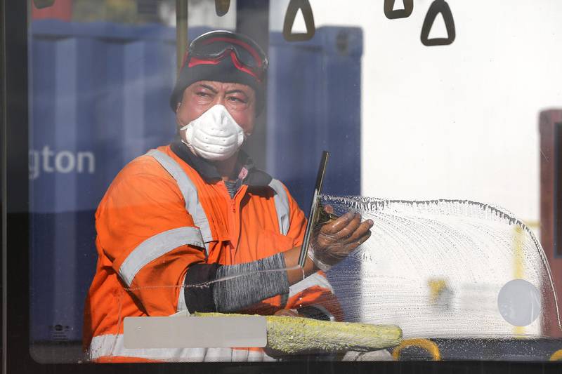 Senior Yard Supervisor Lipi Vitolio the windows of a bus at Tranzit Bus Depot in Wellington, New Zealand. The New Zealand government will decide whether to move to Covid-19 Alert Level 2 and ease further restrictions on Monday, 11 May. Getty Images