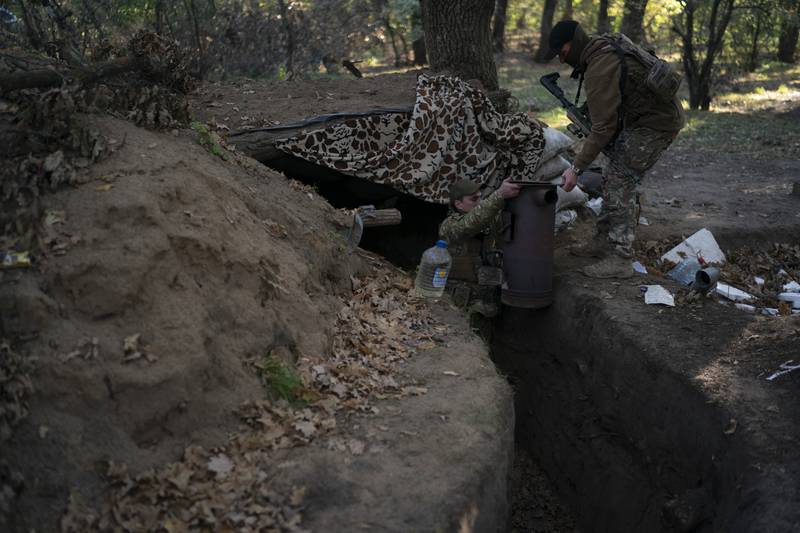 Ukrainian troops check trenches that had been dug by Russian soldiers, in a retaken area of Kherson region in southern Ukraine. AP