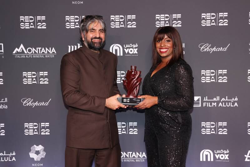 Kaleem Aftab and Charlene Deleon-Jones  with the Film AlUla Audience Award, given to director He Shuming for  Ajoomma in the Best Film category 