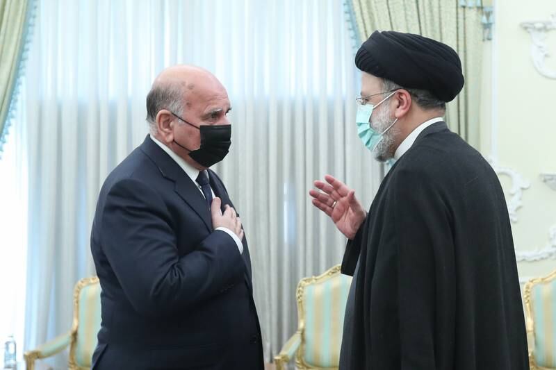 Iranian President Ebrahim Raisi, right, greets Iraqi Foreign Minister Fuad Hussein in Tehran. EPA