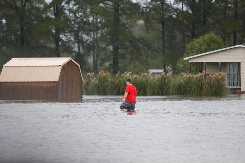 A man walks through a flooded field to his home during Tropical Storm Florence in Lumberton, North Carolina. Reuters