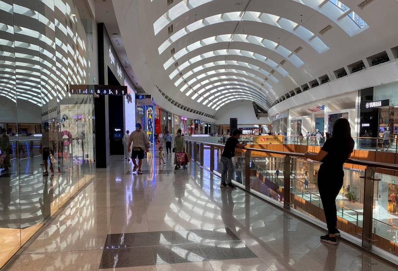 People wearing protective face masks shop at Dubai Mall after the UAE government eased restriction measures and allowed stores to open. Reuters