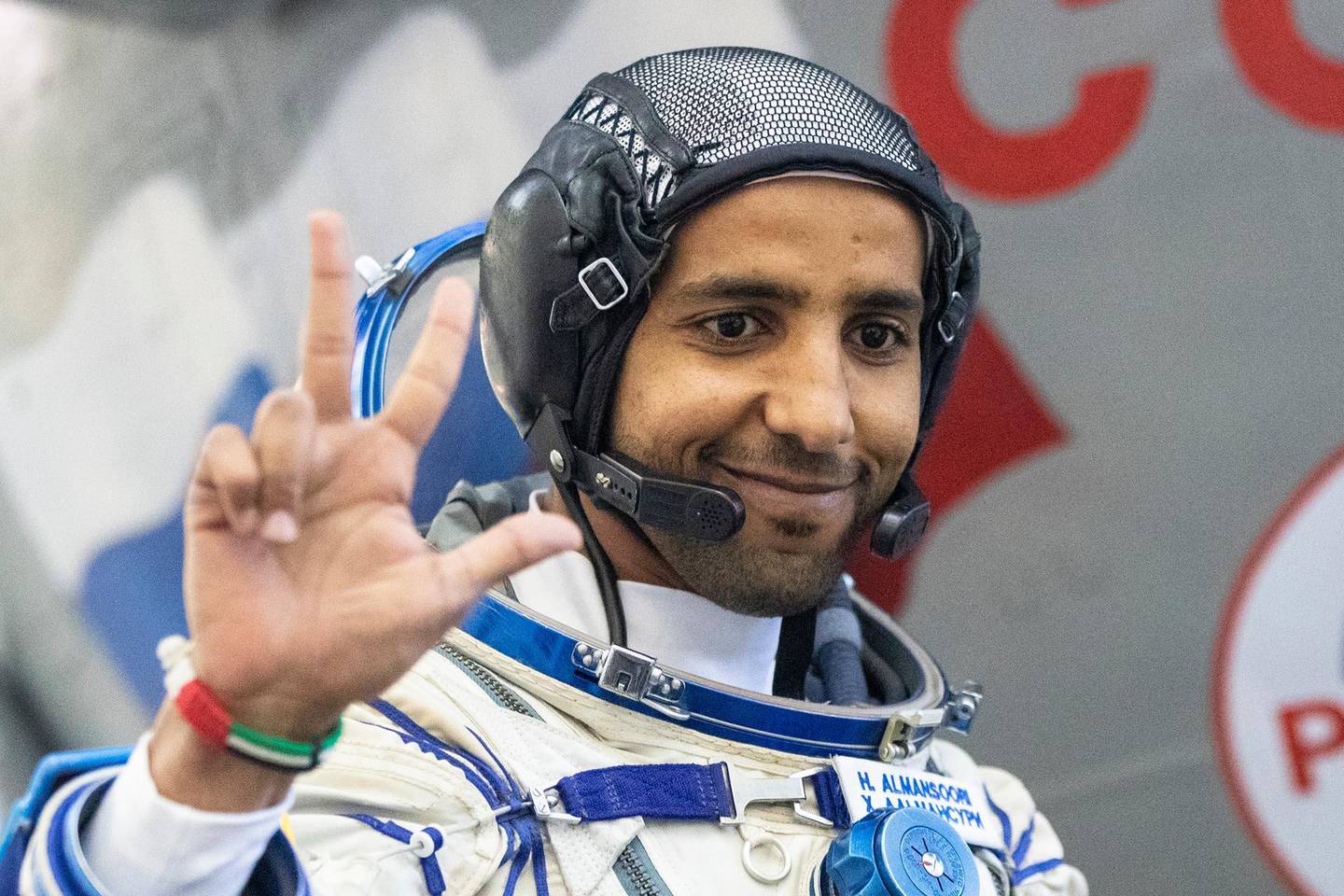 United Arab Emirates astronaut Hazza Al Mansouri gestures before his final preflight practical examination in a mock-up of a Soyuz space craft at Russian Space Training Center in Star City, outside Moscow, Russia, Friday, Aug. 30, 2019. Russian cosmonaut Oleg Skripochkaâ€Ž, U.S. astronaut Jessica Meir and United Arab Emirates astronaut Hazza Al Mansouri are the next crew scheduled to blast off to the International Space Station from the Baikonur Cosmodrome on a Russian made Soyuz MS-15 space craft going to be launched on September 25.  Hand gesture in UAE means Win, Victory, Love.  (AP Photo/Pavel Golovkin)