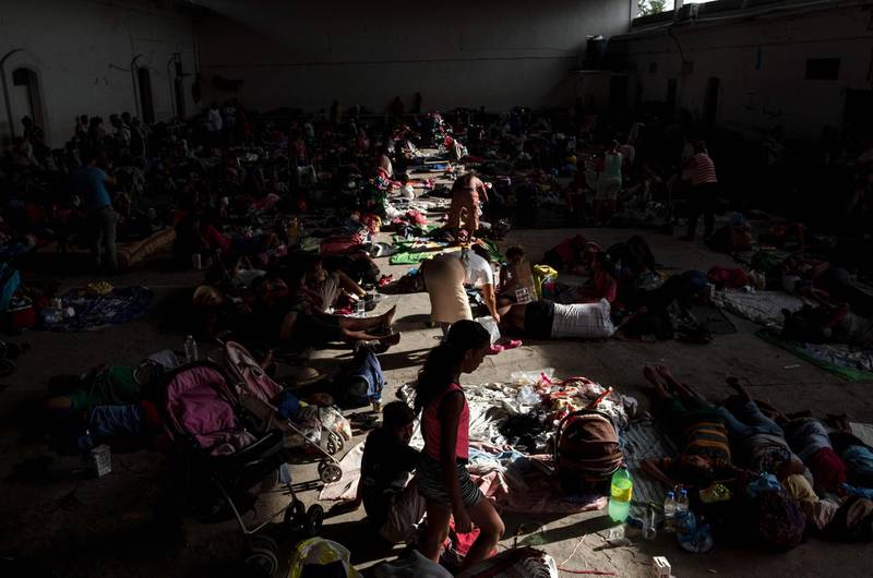 Migrant women and children rest at an improvised shelter in Santiago Niltepec, Oaxaca state, Mexico. AFP