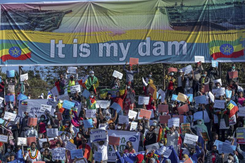 Ethiopians below a banner referring to the Grand Ethiopian Renaissance Dam. AP