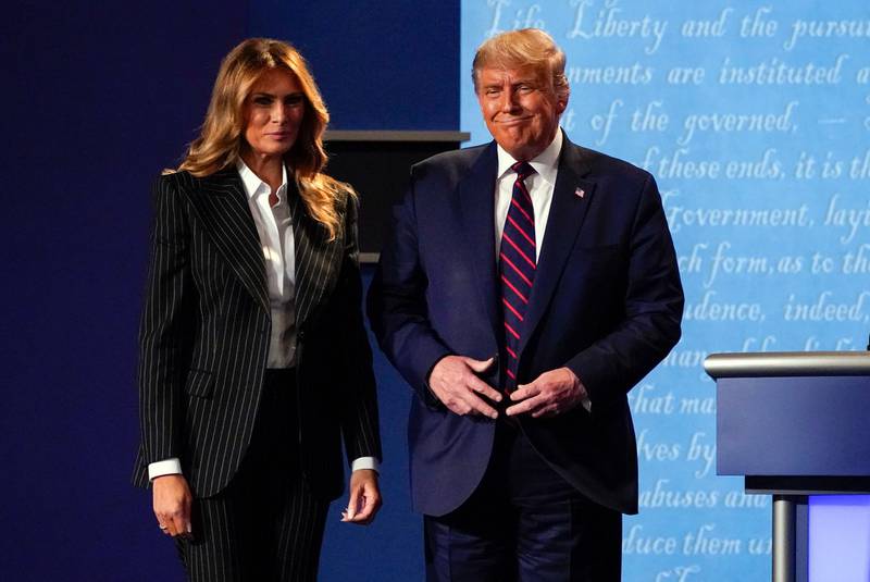 President Donald Trump stands on stage with first lady Melania Trump. AP Photo