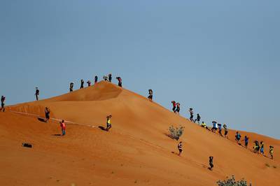 Dubai Spartan Race competitors make their way across dunes in Sharjah, UAE, on November 18, 2016. Francois Nel /Getty Images