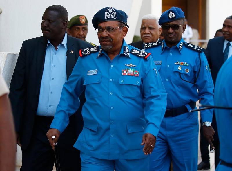 Sudanese President Omar al-Bashir arrives to meet with police officials at the headquarters of the "police house" in the capital Khartoum on December 30, 2018. Sudan's top Islamist party, a member of Bashir's government, called on December 26 for a probe into the killings of protesters in demonstrations that have rocked the economically troubled country. Angry crowds have taken to the streets in Khartoum and several other cities since December 19 when the government tripled the price of bread.
 / AFP / ASHRAF SHAZLY
