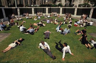 City office workers stretch out during a hot summer lunchtime in Trinity Square in London, in 1993.