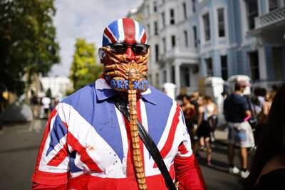 A person wears a Union Flag outfit and a mask with 'Brexit' painted on it during a carnival in London last month. EPA