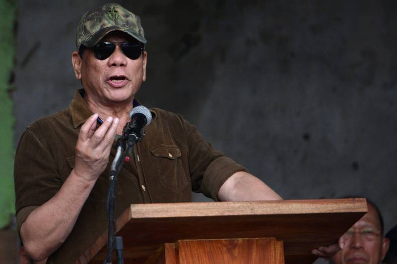 Philippines' President Rodrigo Duterte gestures as he delivers his speech declaring Marawi "liberated" during a ceremony inside the battle area in Marawi on October 17, 2017.
Philippine President Rodrigo Duterte on October 17 symbolically declared a southern city "liberated from terrorists' influence" but the military said the five-month battle against militants loyal to the Islamic State group was not yet over. / AFP PHOTO / Ted ALJIBE