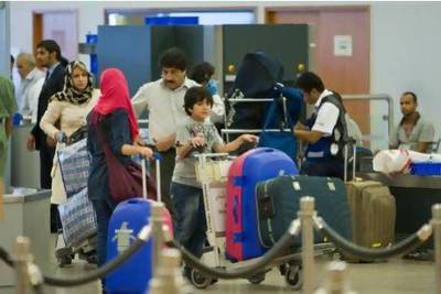 Travellers pass through airport security at Dubai International Airport's Terminal 2. Amy Leang / The National