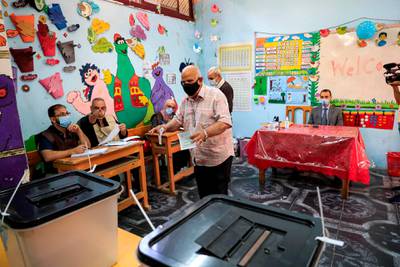 A man prepares to cast his vote at a polling station in the Agouza district in Giza, tEgypt. AFP