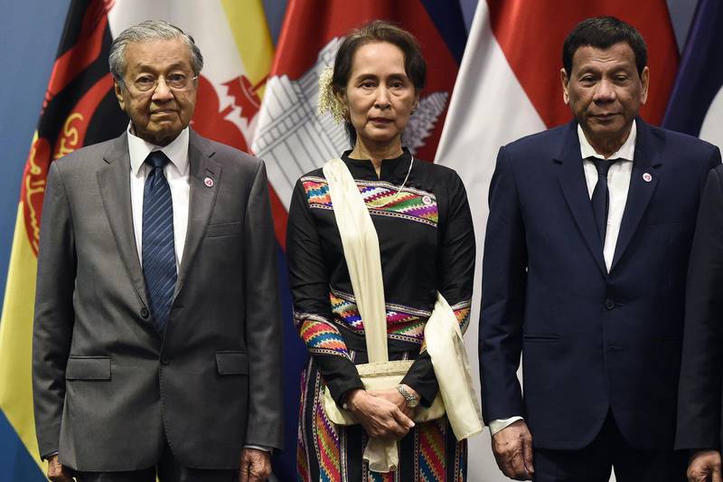Malaysia's Prime Minister Mahathir Mohamad, Myanmar State Counsellor Aung San Suu Kyi and Philippine President Rodrigo Duterte pose for a group photo on the sidelines of the 33rd ASEAN summit in Singapore, 2018.  AFP