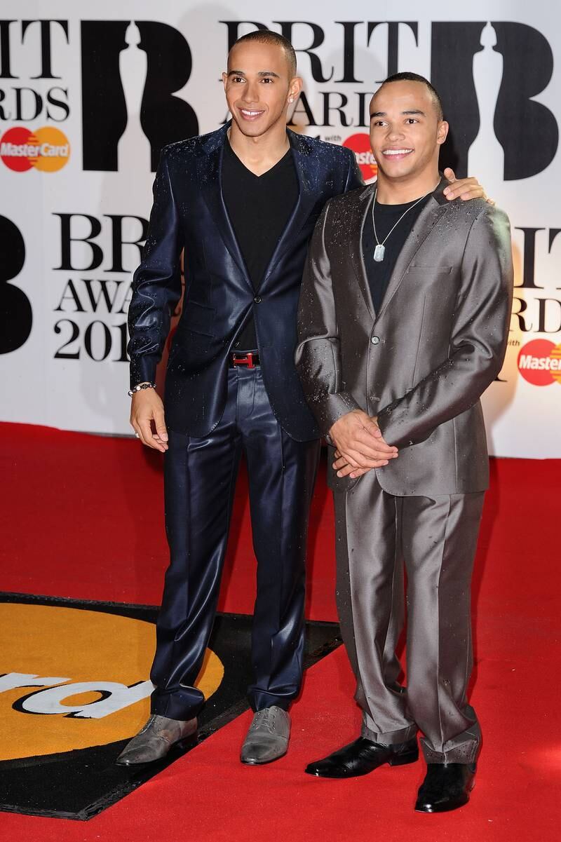Lewis Hamilton, in a blue suit over a black T-shirt, and brother Nicholas Hamilton arrive on the red carpet for The Brit Awards at the O2 Arena on February 15, 2011. Getty Images
