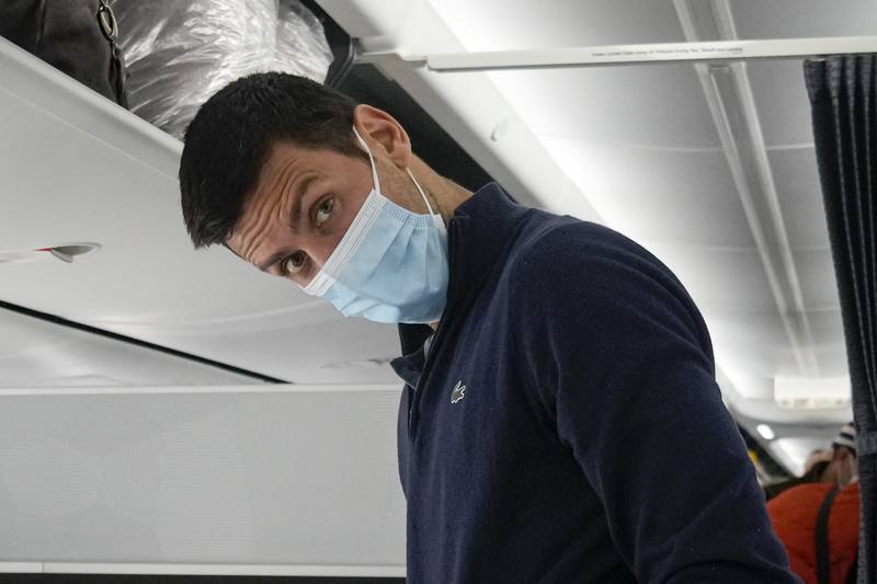 Novak Djokovic prepares to take his seat on a plane to Belgrade from Dubai International Airport on Monday, January 17, 2022. Djokovic was deported from Australia on Sunday after losing a bid to stay in the country to defend his Australian Open title despite not being vaccinated against Covid-19. AP Photo