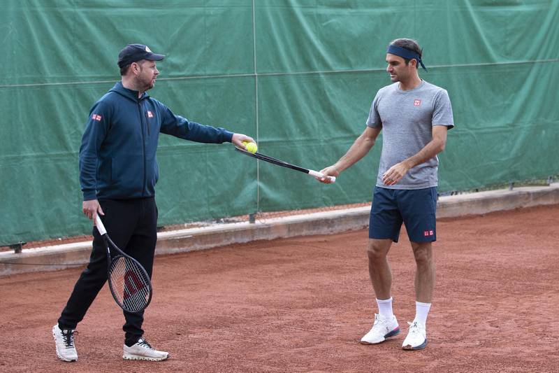 Roger Federer and coach Severin Luethi during training. EPA