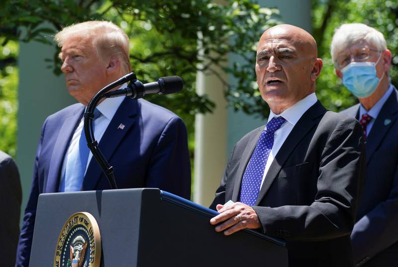 Former GlaxoSmithKline pharmaceutical executive Moncef Slaoui, who will serve as chief adviser on the effort to find a vaccine for the coronavirus disease (COVID-19) pandemic, speaks as President Donald Trump listens during a coronavirus disease response event in the Rose Garden at the White House in Washington, U.S., May 15, 2020. REUTERS/Kevin Lamarque