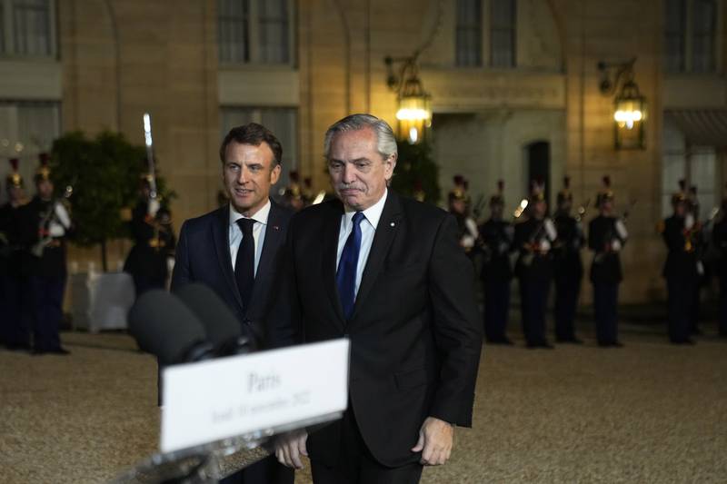 France's President Emmanuel Macron and Argentina's President Alberto Fernandez, right, head to a declaration before their talks at the peace forum held in the Elysee Palace in Paris. AP