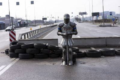 A medieval suit of armour 'stands guard' at a a Ukrainian checkpoint, on the outskirts of the capital Kyiv. AP Photo