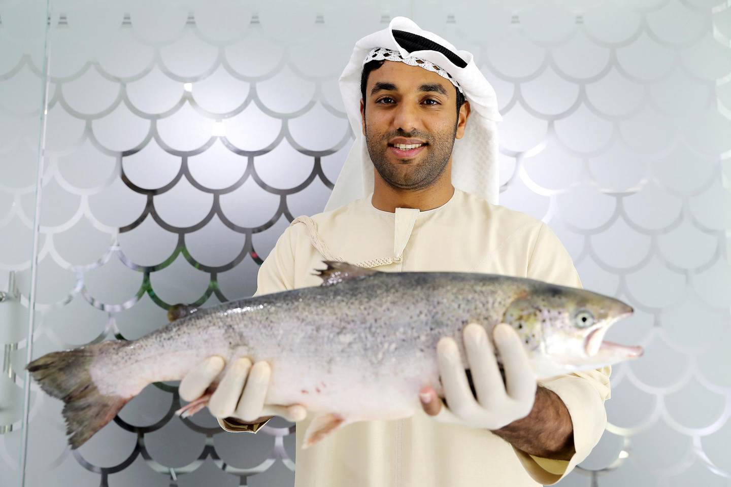 DUBAI , UNITED ARAB EMIRATES , March 27 – 2019 :- Bader Al Mabarak CEO of Dubai’s ‘Fish Farm’ holding the salmon fish at the Fish Farm in Jebel Ali Free Zone in Dubai. ( Pawan Singh / The National ) For Business/Instagarm/Big Picture. Story by Sarah