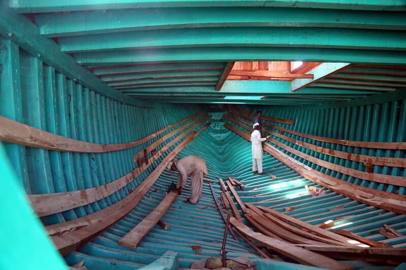 Craftsmen work on a boat at shipyard in Karachi, Pakistan. The shipyard is strategically located on the crossroads of South Asia and Gulf region and builds and repairs vessels for local and foreign customers. EPA
