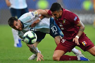 Argentina forward Lionel Messi and Venezuela's Junior Moreno battle for the ball during the Copa Ameerica quarter-final. AFP
