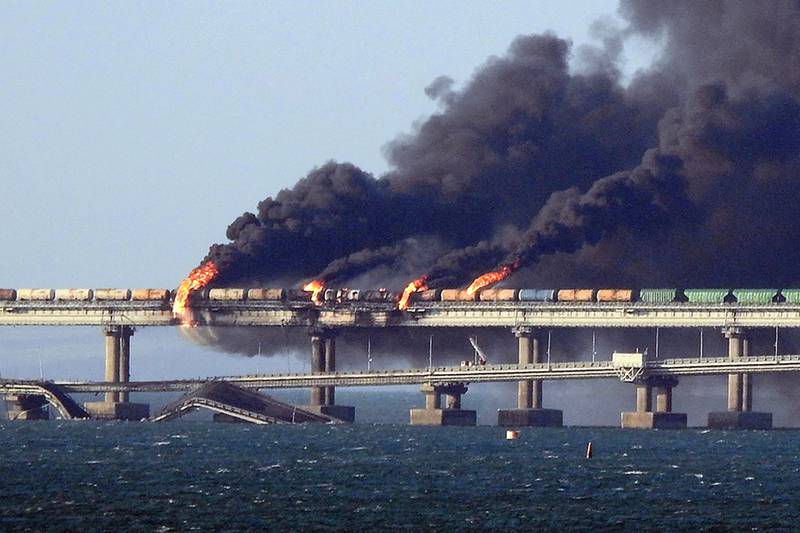 Black smoke billows from the Kerch bridge that links Crimea to Russia after a lorry exploded on October 8. AFP