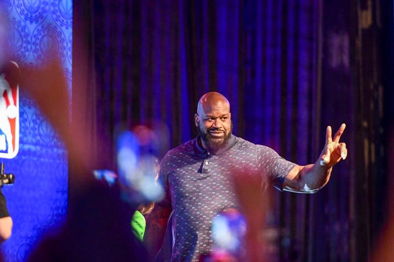 Former basketball champion Shaquille O'Neal makes his way to the stage.
