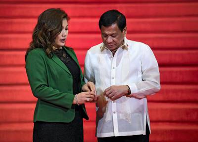 Philippine President Rodrigo Duterte (R) chats with partner Honeylet Avancena (L) while waiting for leaders to arrive to attend the opening ceremony of the Association of Southeast Asian Nations (ASEAN) leaders' summit in Manila on April 29, 2017. - Southeast Asian countries on April 28 expressed "grave concern" over North Korea's nuclear weapons tests and ballistic missile launches, despite Pyongyang's appeal for support in its tense standoff with the United States. (Photo by MOHD RASFAN / AFP)