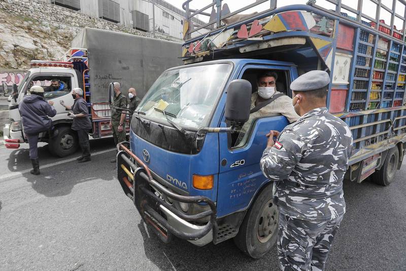 Lebanese security forces stop vehicles at a highway checkpoint in Nahr al-Kalb, north of the Lebanese capital Beirut, as authorities implemented further measures restricting the movement of cars, trucks and motorcycles to three assigned days per week. AFP