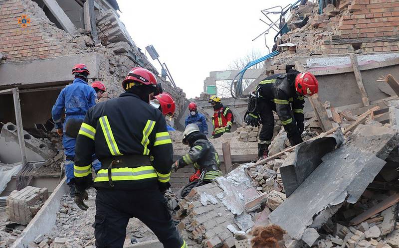 Emergency workers in the rubble of a civilian building after an air strike in Rzhyshchiv, Ukraine. Reuters