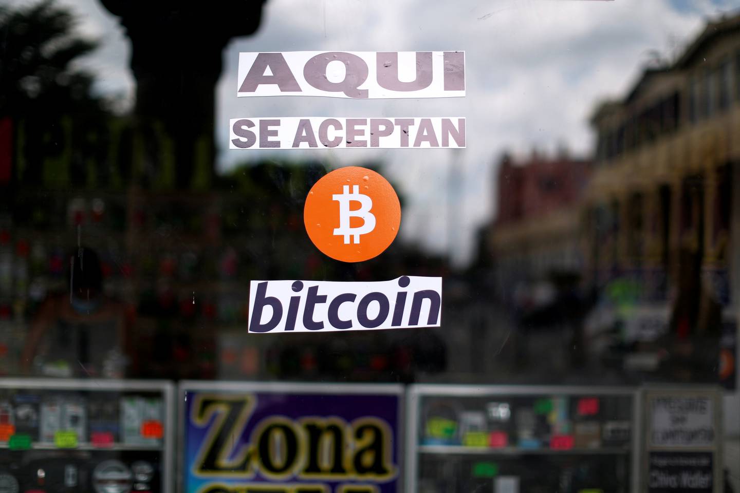 A sign, 'Bitcoin accepted here,, outside a shop in El Salvador. The country's adoption of Bitcoin as legal tender was another step towards mainstream acceptance of the digital currency. Reuters