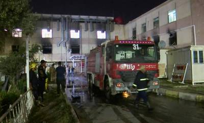 A firefighting vehicle arrives at the scene of a fire that erupted in a Baghdad hospital's intensive care unit for coronavirus patients. AP