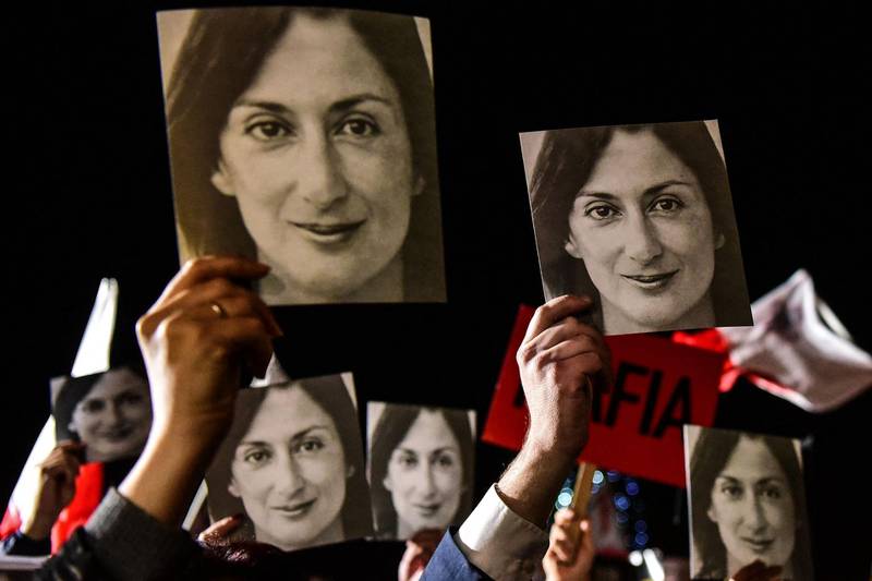 In this photo taken November 29, 2019, placards reading 'Mafia Government' and photos of murdered journalist Daphne Caruana Galizia form part of a protest called by Galizia's family and civic movements outside the office of the prime minister in Valletta, Malta.