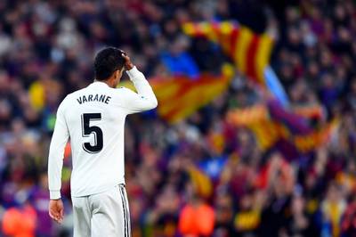 Real Madrid's French defender Raphael Varane reacts to fouling Barcelona's Uruguayan forward Luis Suarez during the Spanish league football match between FC Barcelona and Real Madrid CF at the Camp Nou stadium in Barcelona. AFP