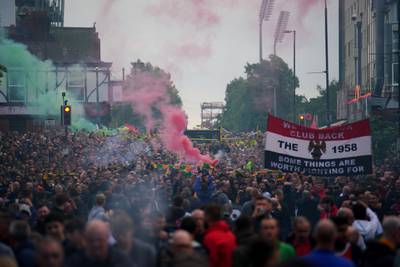 Fans take part in an organised protest march outside Old Trafford.  PA