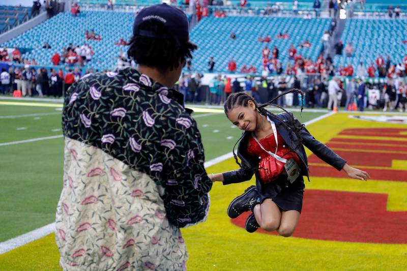 Jay-Z watches his daughter Blue Ivy Carter leap on the field before the NFL Super Bowl 54 football game between the San Francisco 49ers and the Kansas City Chiefs, on Sunday, February 2, 2020, in Miami. AP