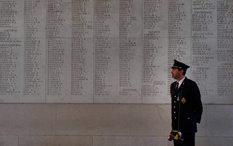 A lone bugler looks at a wall with the names of the missing prior to playing the nightly Last Post under the First World War monument, Menin Gate, in Ypres, Belgium last Saturday. AP Photo