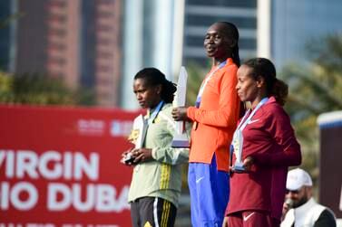 From left, Angela Tanui 2nd place, Eunice Chumba 1st place, and Mare Dibaba 3rd place winners part of the womenÕs elite category during the ADNOC Abu Dhabi Marathon. Khushnum Bhandari / The National
