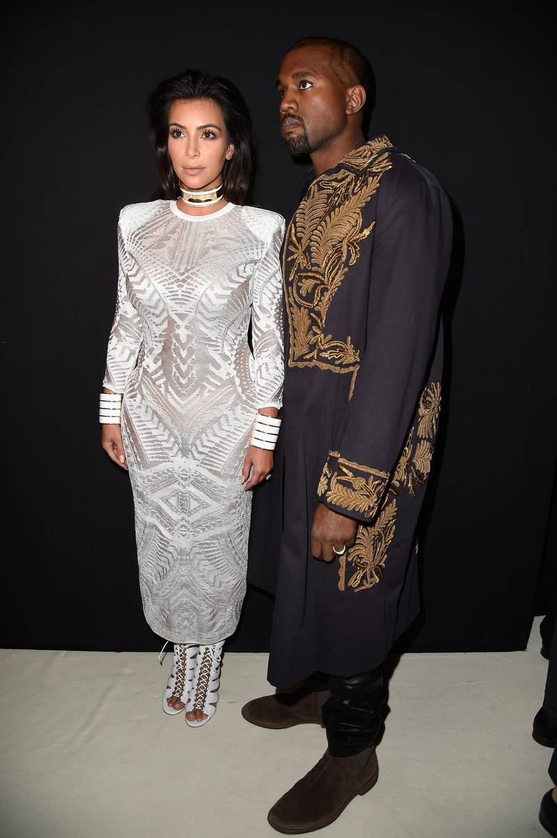 PARIS, FRANCE - SEPTEMBER 25:  (L-R) Kim Kardashian and Kanye West attend the Balmain show as part of the Paris Fashion Week Womenswear Spring/Summer 2015 on September 25, 2014 in Paris, France.  (Photo by Pascal Le Segretain/Getty Images)