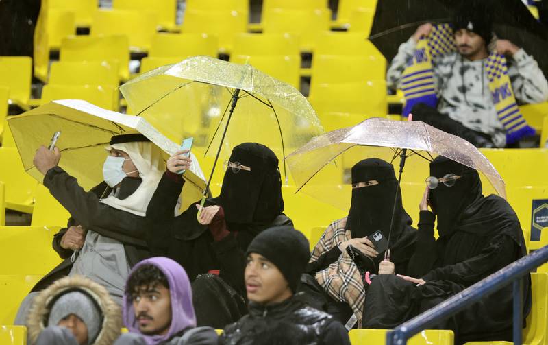 Fans watched Friday's game amid heavy rain and cold. Reuters