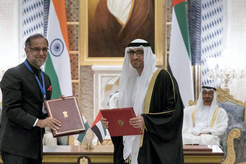 ABU DHABI, UNITED ARAB EMIRATES - February 10, 2018: HH Sheikh Mohamed bin Zayed Al Nahyan Crown Prince of Abu Dhabi Deputy Supreme Commander of the UAE Armed Forces (back R) and HE Narendra Modi, Prime Minister of India (not shown), witness an MOU signing pertaining to 'Cooperation In The Field Of Manpower'. Seen signing are HE Nasser bin Thani Juma Al Hamli, UAE Minister of Human Resources and Emiratisation (R), and HE Navdeep Singh Suri, Ambassador of India to the UAE (L).

( Rashed Al Mansoori / Crown Prince Court - Abu Dhabi )
---